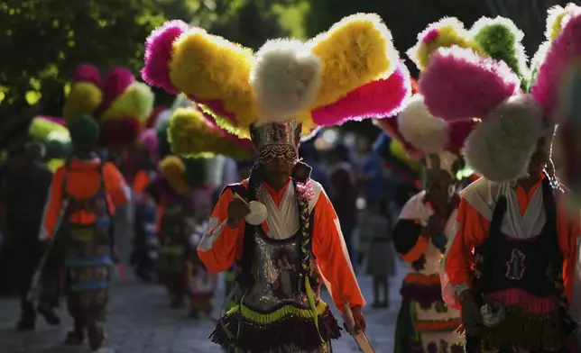 Parishioners dance during St. Mark's Fair, a month-long event honoring the saint, outside St. Mark's church in Aguascalientes, Mexico, Friday, April 25, 2025. (AP Photo/Eduardo Verdugo)