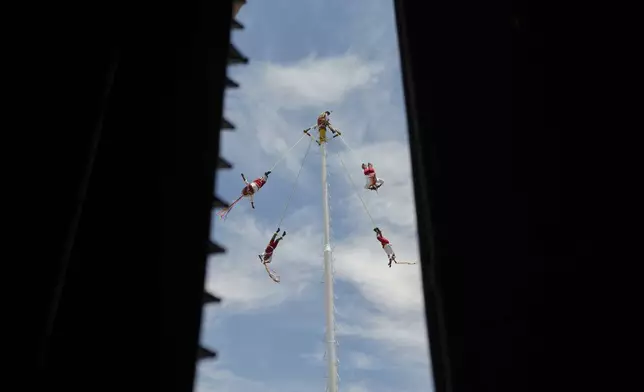Flying men of Papantla perform the "Danza de los Voladores", during St. Mark’s Fair, a month-long event honoring the saint, outside St. Mark's church in Aguascalientes, Mexico, Friday, April 25, 2025. (AP Photo/Eduardo Verdugo)