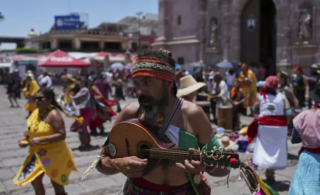Dancers perform on the plaza of the St. Mark church during St. Mark’s Fair, a month-long event honoring the saint, in Aguascalientes, Mexico, Friday, April 25, 2025. (AP Photo/Eduardo Verdugo)