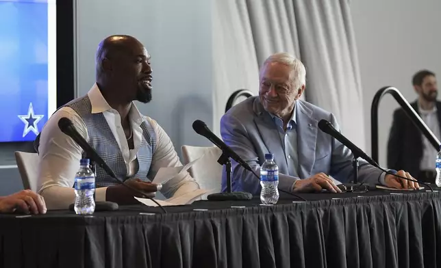 Football player Tyron Smith, left, speaks during a news conference, accompanied by team owner Jerry Jones, where Smith announced his retirement from the NFL at the Dallas Cowboys headquarters in Frisco, Texas, Wednesday, April 16, 2025. (AP Photo/Tony Gutierrez)