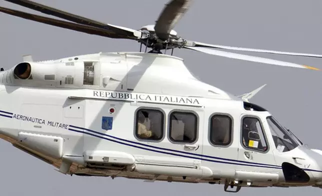 FILE - The helicopter carrying Pope Francis, sitting by the window at left, flies on its way to Castel Gandolfo, south of Rome, on March 23, 2013, to meet with Emeritus Pope Benedict XVI, where he has been living since resigning on Feb. 28, 2013. (AP Photo/Andrew Medichini, file)