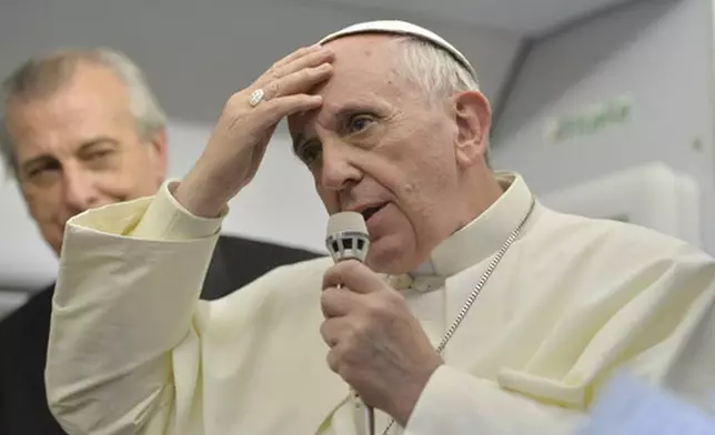 FILE - Pope Francis speaks during a news conference aboard the papal flight on its way back from Brazil, Monday, July 29, 2013. Pope Francis reached out to gays on Monday, saying he wouldn't judge priests for their sexual orientation in a remarkably open and wide-ranging news conference as he returned from his first foreign trip. "If someone is gay and he searches for the Lord and has good will, who am I to judge?" Francis asked. (Luca Zennaro/Pool Photo via AP, File)