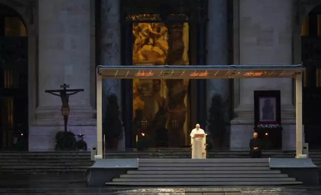 FILE - Pope Francis, standing alone at center, delivers an Urbi et orbi prayer from the empty St. Peter's Square, at the Vatican, Friday, March 27, 2020. “We have realized that we are on the same boat, all of us fragile and disoriented, but at the same time, important and needed, all of us called to row together, each of us in need of comforting the other.” (AP Photo/Alessandra Tarantino, File)