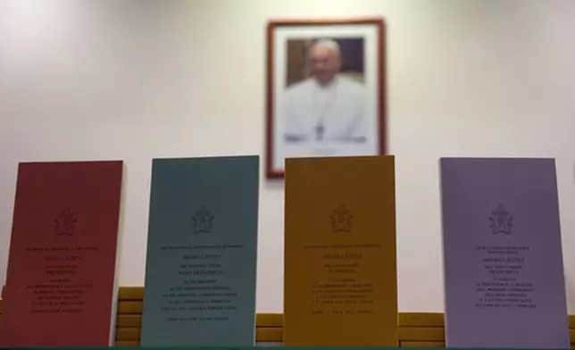 FILE - Copies of the post-synodal apostolic encyclical 'Amoris Laetitia' (The Joy of Love) document, by Pope Francis, are on display prior to the start of a press conference, at the Vatican, Friday, April 8, 2016. "Footnote 351; "I want to remind priests that the confessional must not be a torture chamber, but rather an encounter with the Lord's mercy. I would also point out that the Eucharist is not a prize for the perfect, but a powerful medicine and nourishment for the weak." (AP Photo/Andrew Medichini, File)