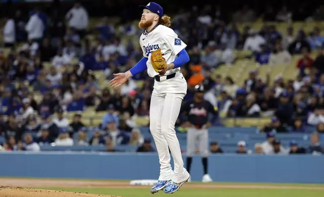 Los Angeles Dodgers' Dustin May jumps in the air after striking out the side against the Atlanta Braves during the first inning of a baseball game Tuesday, April 1, 2025, in Los Angeles. (AP Photo/Kevork Djansezian)