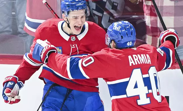 Montreal Canadiens' Ivan Demidov (93) celebrates with teammate Joel Armia (40) after scoring against the Chicago Blackhawks during first-period NHL hockey game action in Montreal, Monday, April 14, 2025. (Graham Hughes/The Canadian Press via AP)