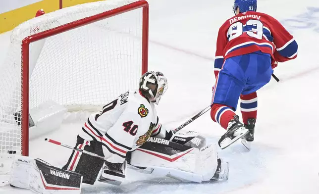 Montreal Canadiens' Ivan Demidov (93) scores against Chicago Blackhawks goaltender Arvid Soderblom (40) during first-period NHL hockey game action in Montreal, Monday, April 14, 2025. (Graham Hughes/The Canadian Press via AP)