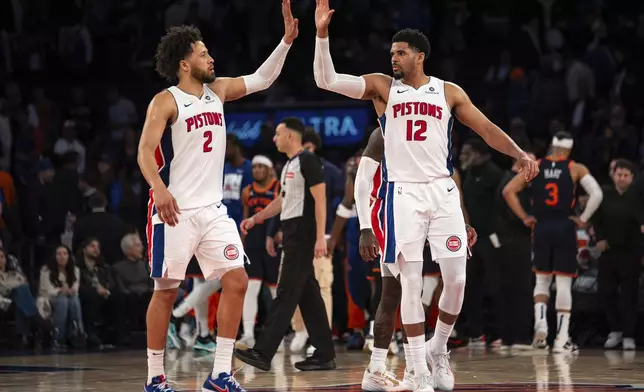 Detroit Pistons guard Cade Cunningham (2) and forward Tobias Harris (12) high-five at the end of Game 2 of an NBA basketball first-round playoff series against the New York Knicks, Monday, April 21, 2025, in New York. (AP Photo/Angelina Katsanis)