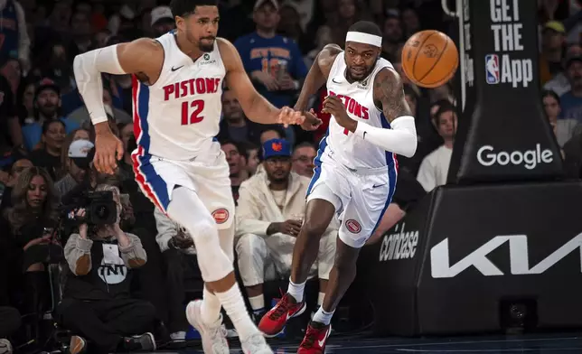 Detroit Pistons forwards Paul Reed, right, and Tobias Harris (12) race for a rebound ball during the first quarter of Game 2 of an NBA basketball first-round playoff series against the New York Knicks, Monday, April 21, 2025, in New York. (AP Photo/Angelina Katsanis)