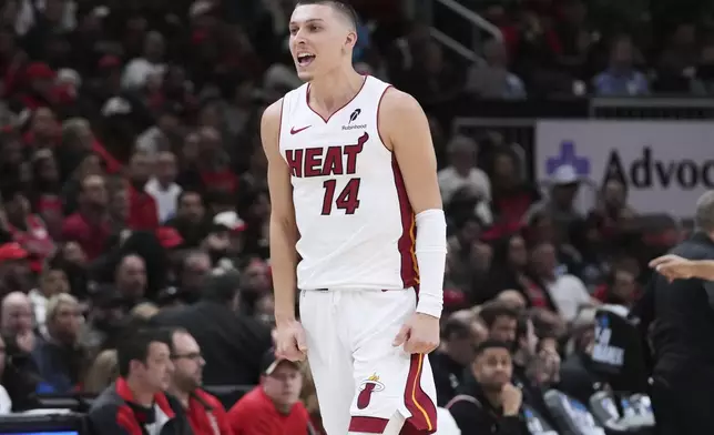 Miami Heat guard Tyler Herro reacts after scoring a basket during the second half of an NBA play-in tournament basketball game against the Miami Heat in Chicago, Wednesday, April 16, 2025. (AP Photo/Nam Y. Huh)