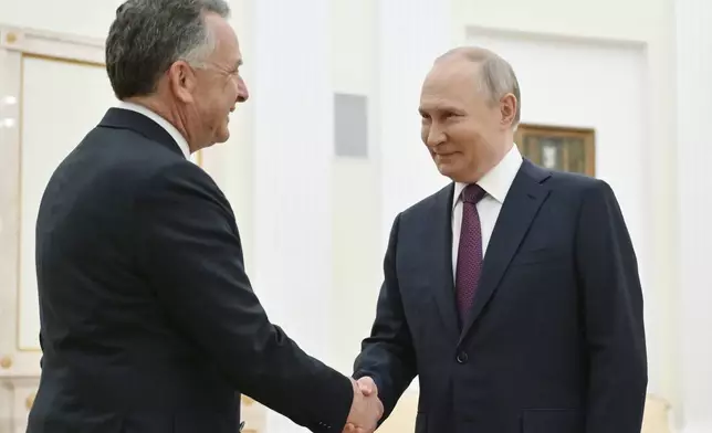Russian President Vladimir Putin, right, and U.S. President Donald Trump's special envoy Steve Witkoff greet each other prior to their talks at the Kremlin in Moscow, Russia, Friday, April 25, 2025. (Kristina Kormilitsyna, Sputnik, Kremlin Pool Photo via AP)