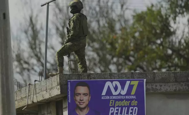 A soldier stands guard during a campaign rally for Ecuador's President Daniel Noboa, who is running for re-election, in Pelileo, Ecuador, Wednesday, April 2, 2025. (AP Photo/Dolores Ochoa)