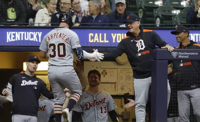 Detroit Tigers' Kerry Carpenter (30) receives congratulations after hitting a home run during the fifth inning of a baseball game against the Milwaukee Brewers, Monday, April 14, 2025, in Milwaukee. (AP Photo/Jeffrey Phelps)