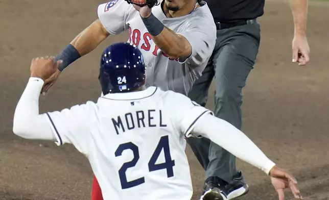 Boston Red Sox shortstop David Hamilton prepares to tag out Tampa Bay Rays' Christopher Morel (24) attempting to steals second base during the fourth inning of a baseball game Wednesday, April 16, 2025, in Tampa, Fla. (AP Photo/Chris O'Meara)