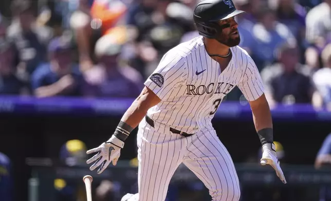 Colorado Rockies' Nick Martini flies out against Milwaukee Brewers starting pitcher Quinn Priester to end the third inning of a baseball game Thursday, April 10, 2025, in Denver. (AP Photo/David Zalubowski)