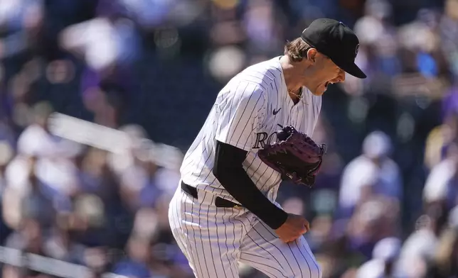 Colorado Rockies starting pitcher Ryan Feltner reacts after striking out Milwaukee Brewers' Eric Haase with the bases loaded to end the top of the fourth inning of a baseball game Thursday, April 10, 2025, in Denver. (AP Photo/David Zalubowski)
