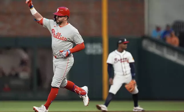Philadelphia Phillies designated hitter Kyle Schwarber (12) celebrates his solo homer against the Atlanta Braves in the third inning of a baseball game, Thursday, April 10, 2025, in Atlanta. (AP Photo/Mike Stewart)