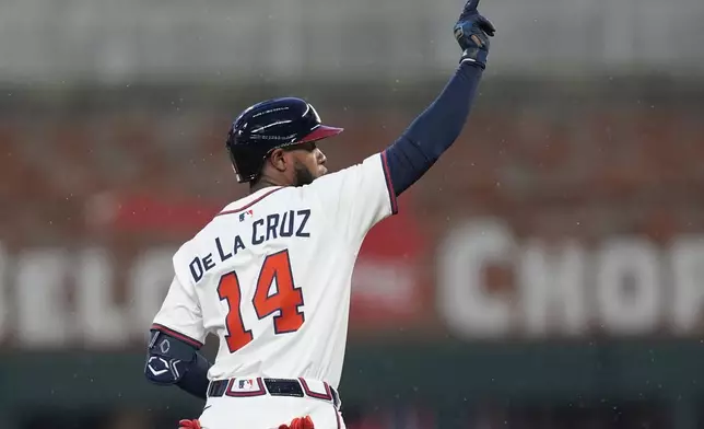Atlanta Braves' Bryan De La Cruz (14) celebrates his double against the Philadelphia Phillies in the second inning of a baseball game, Thursday, April 10, 2025, in Atlanta. (AP Photo/Mike Stewart)