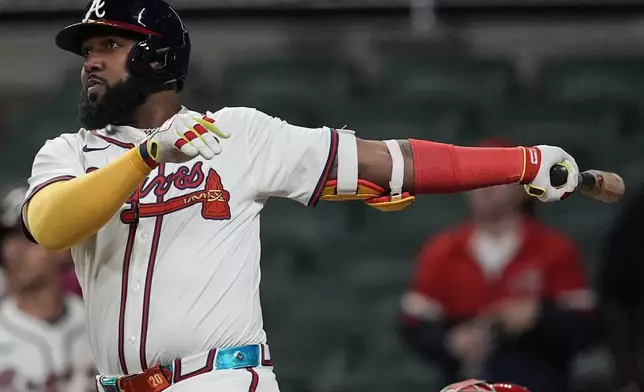 Atlanta Braves designated hitter Marcell Ozuna (20) hits a walk-off two-run homer in the 11th inning of a baseball game after a rain delay against the Philadelphia Phillies, Friday, April 11, 2025, in Atlanta. (AP Photo/Mike Stewart)