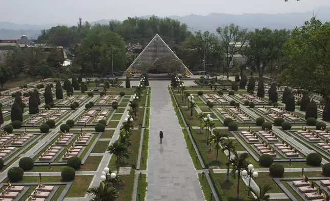 A tourist walks through the Dien Bien Phu Military Cemetery in Dien Bien Phu, Vietnam, April 22, 2019. (AP Photo/David Rising)