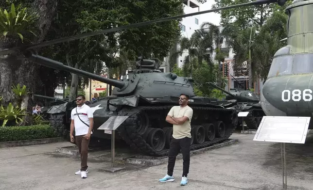 Tourists stand in front of armor combat vehicles on display at the War Remnants Museum in Ho Chi Minh City, Vietnam, Feb. 22, 2025. (AP Photo/Hau Dinh)