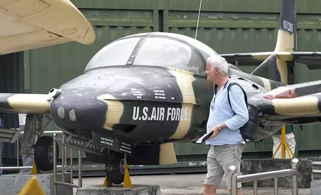 A tourist looks at a U.S Air Force fighter jet used during the Vietnam war on display at the War Remnants Museum in Ho Chi Minh City, Vietnam, Feb. 22, 2025. (AP Photo/Hau Dinh)