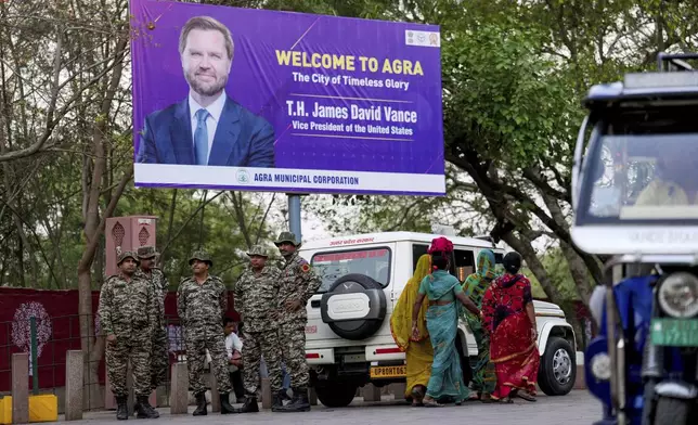 Security personnel stand guard on a road leading to the Taj Mahal under the banner welcoming U.S. Vice President JD Vance in Agra, India, Tuesday, April 22, 2025. (AP Photo/Rajesh Kumar Singh)