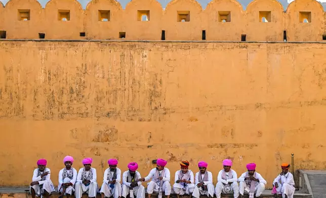 Men wearing traditional attire sit in the shade prior to conducting a cultural performance for U.S. Vice President JD Vance and his family at Amber Fort, a historical site, in Jaipur, India, Tuesday, April 22, 2025. (Kenny Holston/The New York Times via AP, Pool)