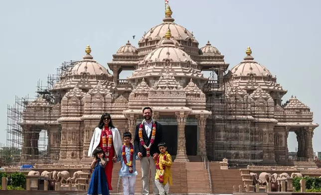 U.S. Vice President JD Vance, second Lady Usha Vance and their children pose for a photo in front of the Akshardham Temple, a sprawling cultural site dedicated to Hindu cultural heritage and spirituality in New Delhi, India, Monday, April 21, 2025. (Kenny Holston/The New York Times via AP, Pool)