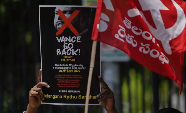 An activist of Samyukt Kisan Morcha holds a placard during a protest against the visit of U.S. Vice President JD Vance to India, in Hyderabad, India, Monday, April 21, 2025. (AP Photo/Mahesh Kumar A.)