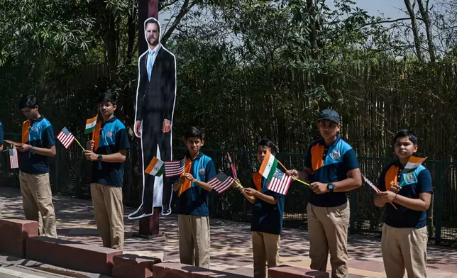 A life size cutout of U.S. Vice President JD Vance is seen as children, line the street to see U.S. Vice President JD Vance's motorcade pass by en route to the Taj Mahal in Agra, India, Wednesday, April 23, 2025. (Kenny Holston/The New York Times via AP, Pool)