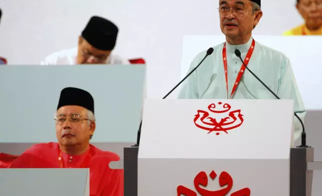 FILE - Malaysia's Prime Minister Abdullah Ahmad Badawi, right, delivers his keynote address United Malays National Organization (UMNO) annual general assembly in Kuala Lumpur, Thursday, March 26, 2009. (AP Photo/Vincent Thian, File)