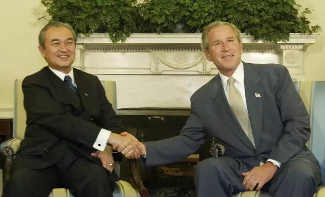 FILE - President George W. Bush, right, greets Malaysian Prime Minister Abdullah Ahmad Badawi in the Oval Office of the White House, Monday, July 19, 2004, in Washington. (AP Photo/Pablo Martinez Monsivais, File)