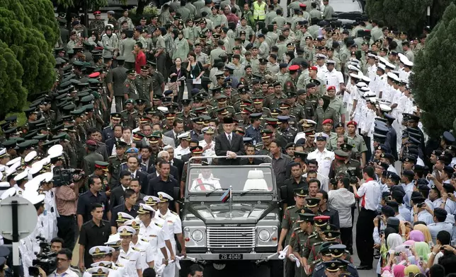 FILE - Malaysian outgoing Prime Minister Abdullah Ahmad Badawi, also Defence Minister, center, looks on during a farewell ceremony organised by the Defence Ministry in Kuala Lumpur, Malaysia, Thursday, April 2, 2009. (AP Photo/Lai Seng Sin, File)