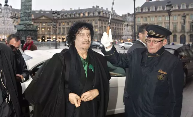 FILE - Libyan Col. Muammar Gadhafi arrives for a meeting with intellectuals at the Ritz Hotel in Paris, Dec. 11, 2007. (AP Photo/Francois Mori, File)