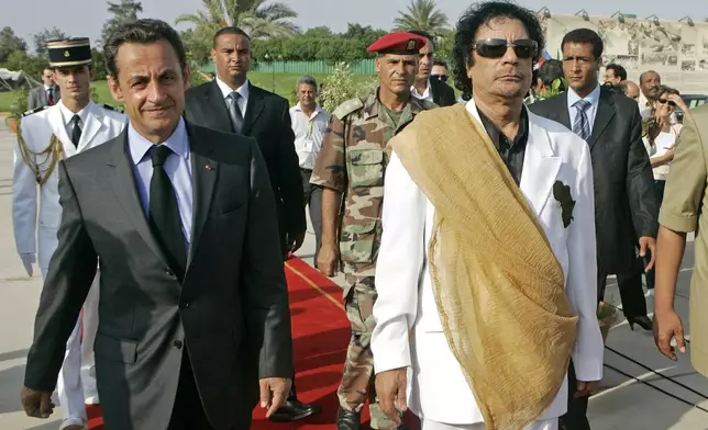 FILE - Libyan leader Moammar Gadhafi, right, welcomes French President Nicolas Sarkozy at the Bab Azizia Palace in Tripoli, July 25, 2007. (AP Photo/Michel Euler, File)