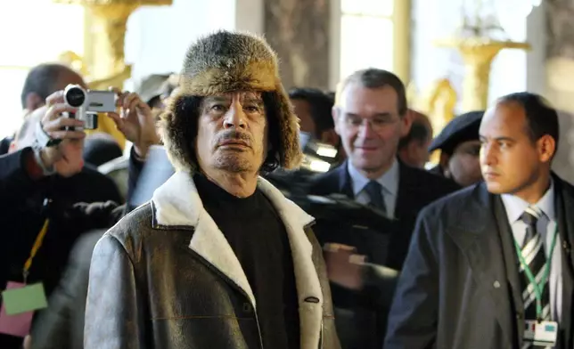 FILE - Libyan leader Col. Moammar Gadhafi, foreground, visits the Chateau de Versailles, southwest of Paris, Dec. 14, 2007. (AP Photo/Patrick Kovarik, Pool, File)