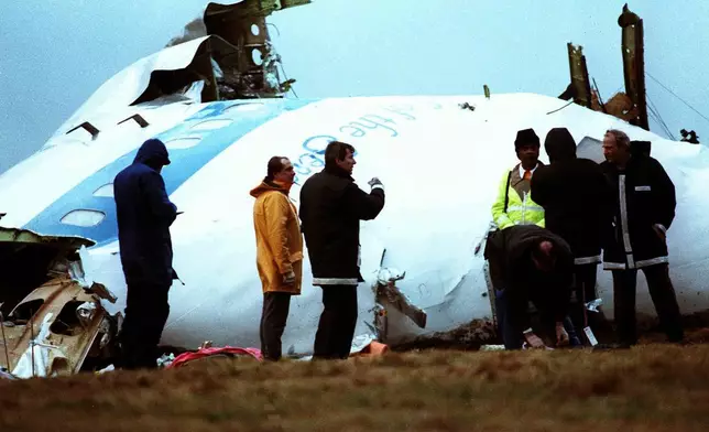 FILE - Investigators inspect the nose section of the crashed Pan Am flight 103, a Boeing 747 airliner in a field near Lockerbie, Scotland, Dec. 23, 1988. (AP Photo/Dave Caulkin, File)