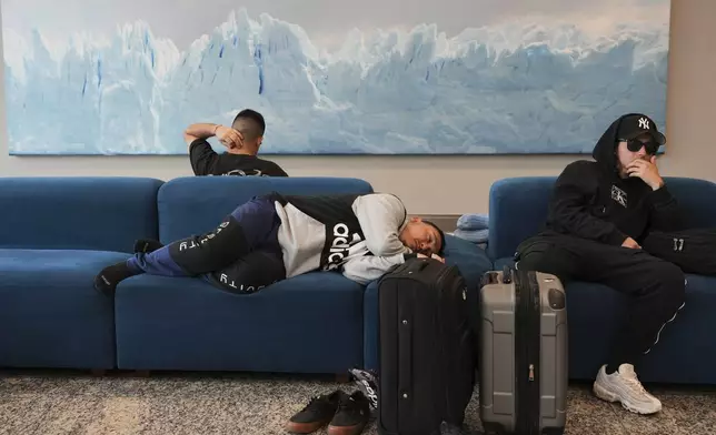 Stranded passengers wait at Jorge Newbery airport during a general strike against the austerity measures of President Javier Milei in Buenos Aires, Argentina, Thursday, April 10, 2025. (AP Photo/Rodrigo Abd)
