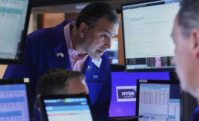 Trader Christopher Lagana works with colleagues on the floor of the New York Stock Exchange, Thursday, April 24, 2025. (AP Photo/Richard Drew)
