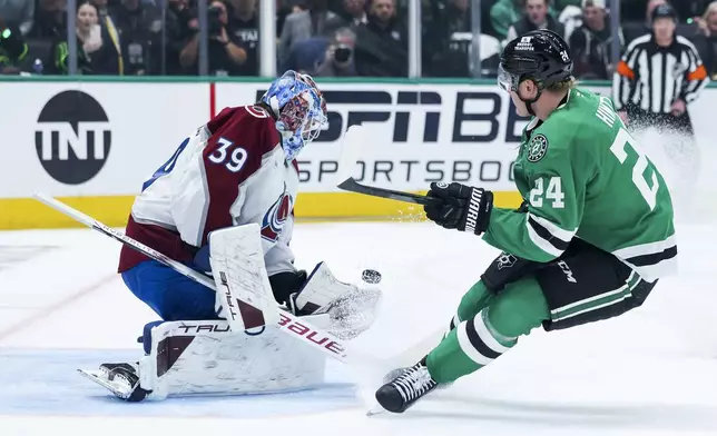 Dallas Stars center Roope Hintz (24) shoots against Colorado Avalanche goaltender Mackenzie Blackwood (39) during a first-round NHL hockey playoff game in Dallas, Saturday, April 19, 2025. (AP Photo/Gareth Patterson)