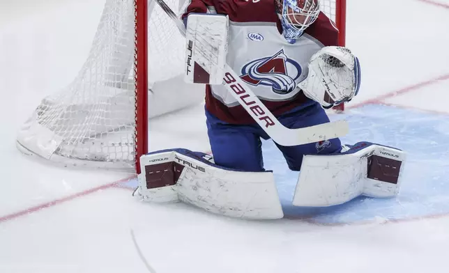Dallas Stars left wing Mason Marchment, bottom, misses a shot against Colorado Avalanche goaltender Mackenzie Blackwood, top, during a first-round NHL hockey playoff game in Dallas, Saturday, April 19, 2025. (AP Photo/Gareth Patterson)