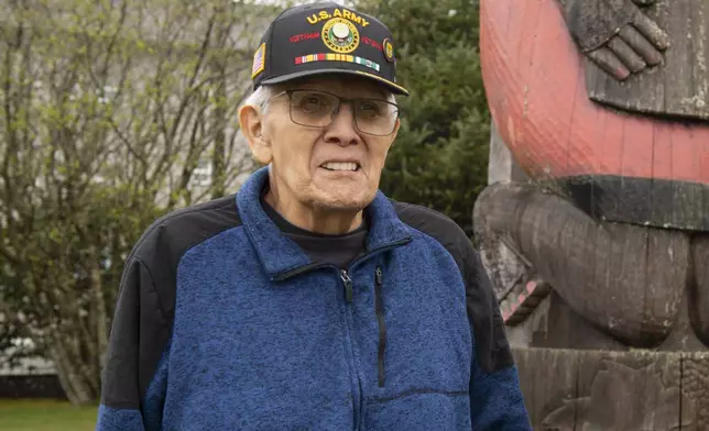 George Bennett stands in front of a totem on the Southeast Alaska Health Consortium campus in Sitka, Alaska, Monday, April 28, 2025. (James Poulson/The Daily Sitka Sentinel via AP)