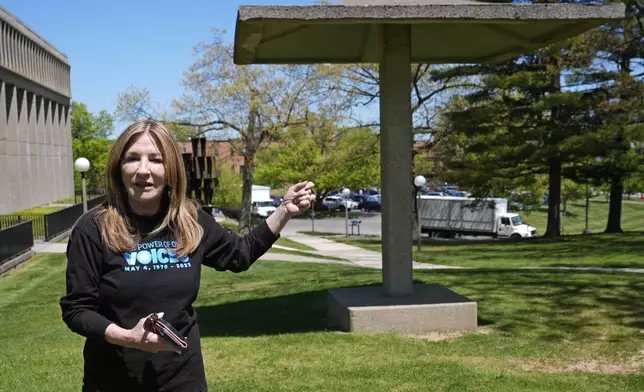 FILE - Chic Canfora recounts the events of May 4, 1970, standing at the pagoda where National Guardsmen knelt and shot towards students in the parking lot at rear, during an interview Thursday, May 2, 2024, in Kent, Ohio. (AP Photo/Sue Ogrocki, File)