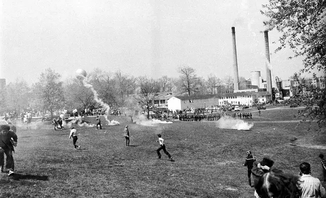 FILE - A general view shows tear gas and students during an anti-Vietnam war protest at Kent State University in Kent Ohio, May 4, 1970. U.S. National Guardsmen opened fire during the protests killing four students and wounding five. (AP Photo/Larry Stoddard, File)