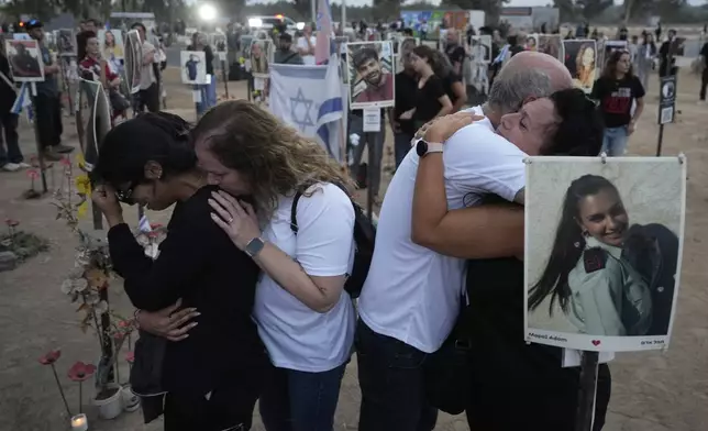 FILE - People visit the site of the Nova music festival, where hundreds of revelers were killed and abducted by Hamas and taken into Gaza, on the one-year anniversary of the attack, near Kibbutz Reim, southern Israel, Oct. 7, 2024. (AP Photo/Ariel Schalit, File)