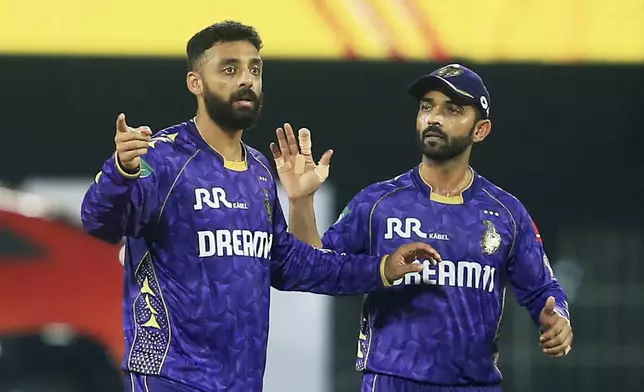 Kolkata Knight Riders' Varun Chakravarthy, left, and Kolkata Knight Riders' captain Ajinkya Rahane celebrates the dismissal of Chennai Super Kings' Vijay Shankar during the Indian Premier League cricket match between Chennai Super Kings and Kolkata Knight Riders at M. A. Chidambaram Stadium in Chennai, India, Friday, April 11, 2025. (AP Photo/R. Parthibhan)
