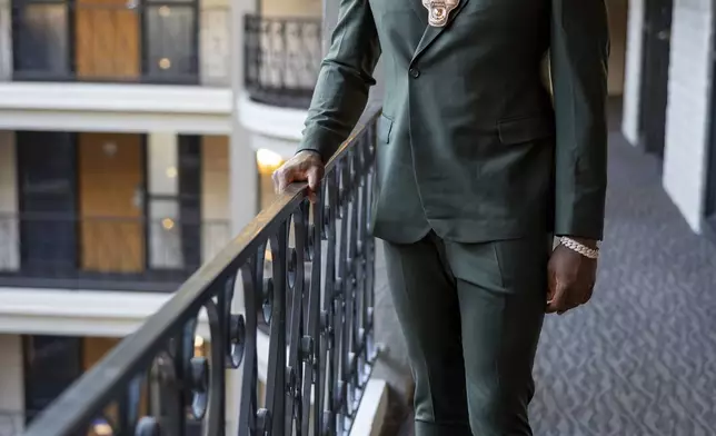 Texas A&amp;M edge rusher Shemar Stewart tries on a suit from designer Baynes + Baker ahead of the NFL Draft, Wednesday, April 23, 2025, in Green Bay, Wis. (AP Photo/Matt Ludtke)