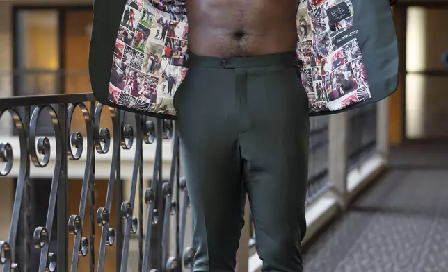 Texas A&amp;M edge rusher Shemar Stewart tries on a suit from designer Baynes + Baker ahead of the NFL Draft, Wednesday, April 23, 2025, in Green Bay, Wis. (AP Photo/Matt Ludtke)
