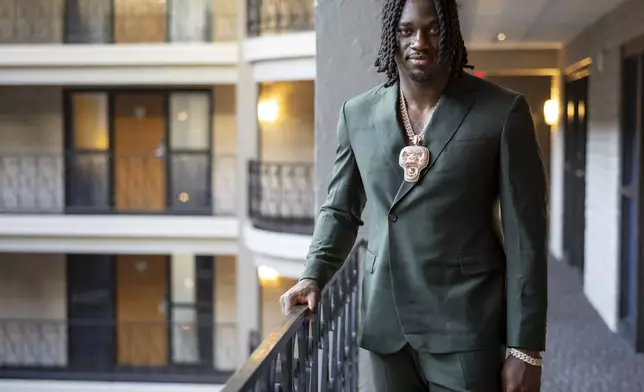Texas A&amp;M edge rusher Shemar Stewart tries on a suit from designer Baynes + Baker ahead of the NFL Draft, Wednesday, April 23, 2025, in Green Bay, Wis. (AP Photo/Matt Ludtke)